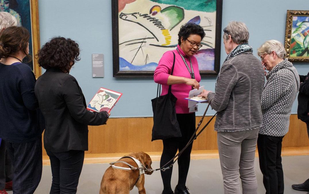 Visuele beperkte bezoekers voelen tactiele tekeningen in een museum