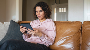 persoon die zittend op een bank op een ipad leest